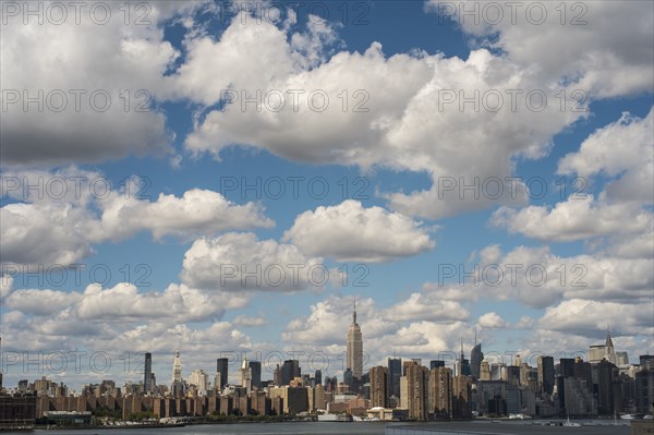 New York City skyline under cloudy blue sky