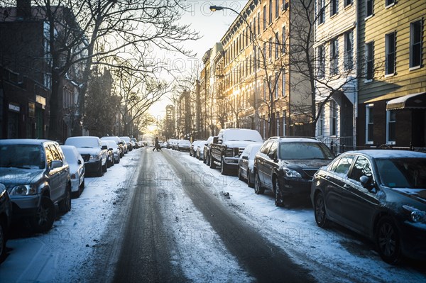 Tire tracks in snow on city street