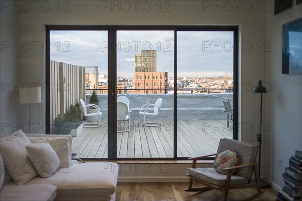 Modern living room and patio on urban rooftop