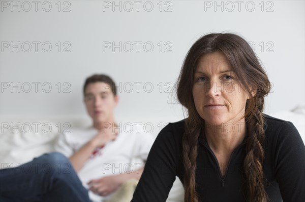 Caucasian mother and son sitting in living room