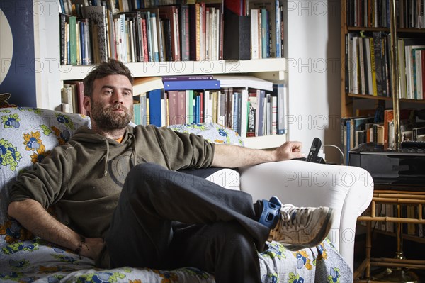 Caucasian man sitting on sofa in living room