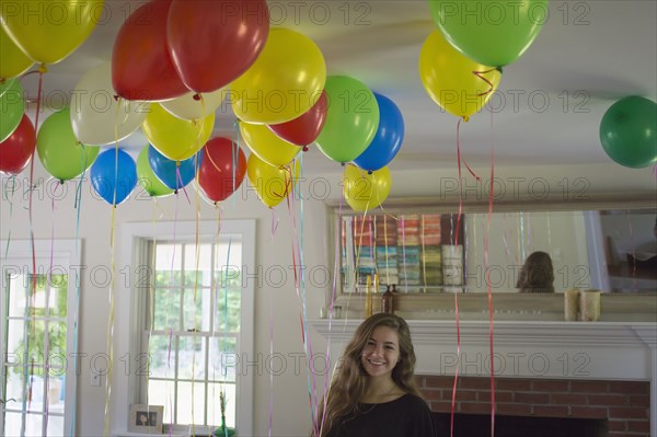 Caucasian teenage girl smiling at party