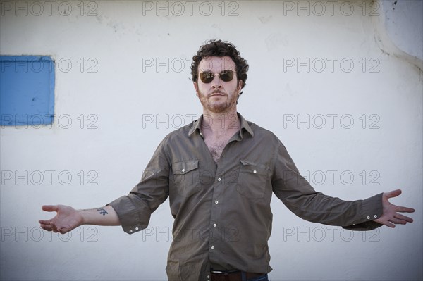 Caucasian man standing with arms outstretched outdoors