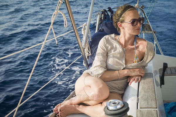 Caucasian woman sitting on boat deck