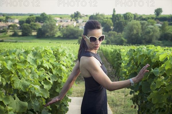 Playful Caucasian woman in vineyard