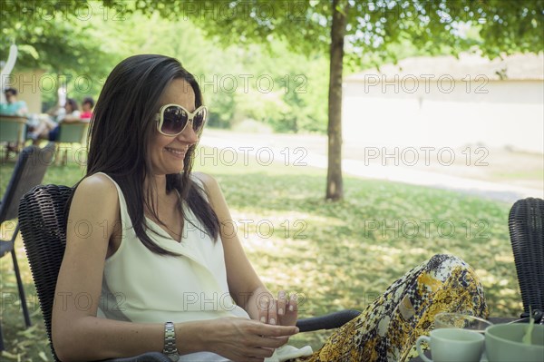 Caucasian woman sitting in chair in backyard