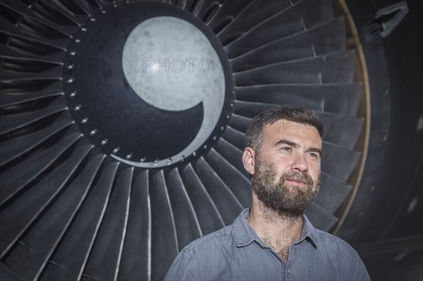 Caucasian man standing under spiral fan