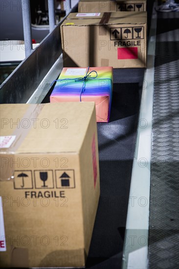 High angle view of colorful package on conveyor belt