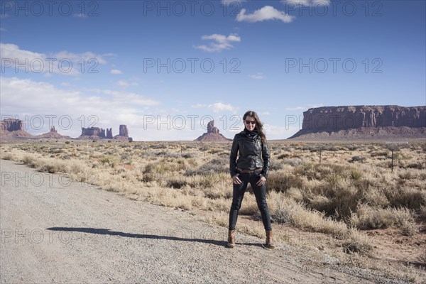 Caucasian woman standing on desert dirt road