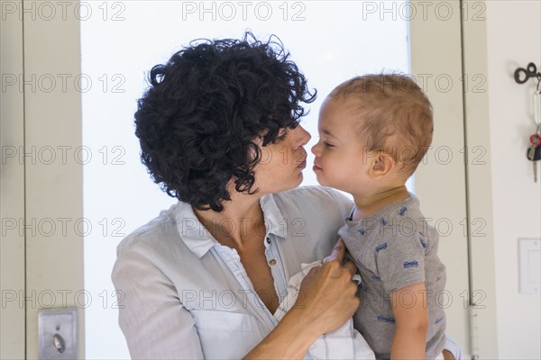 Caucasian mother kissing baby son