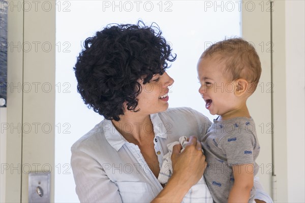 Caucasian mother kissing baby son