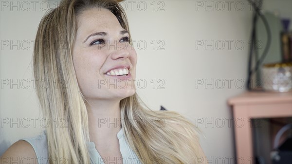 Caucasian woman smiling in living room