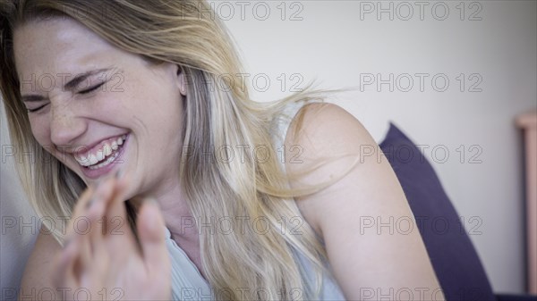 Caucasian woman laughing in living room