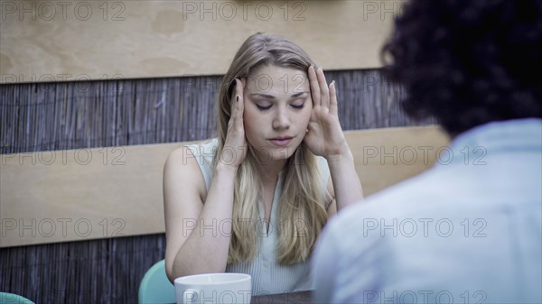 Stressed Caucasian woman sitting at table
