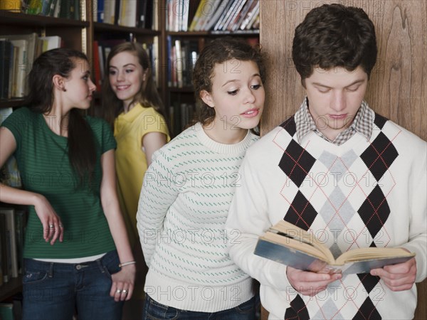 Students reading book in library