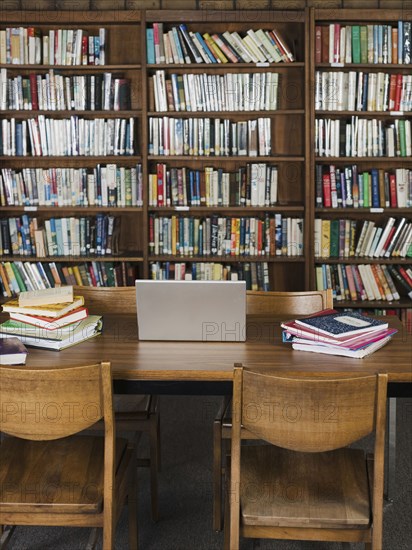 Empty chairs and table in library