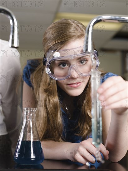 Student examining sample in science lab classroom