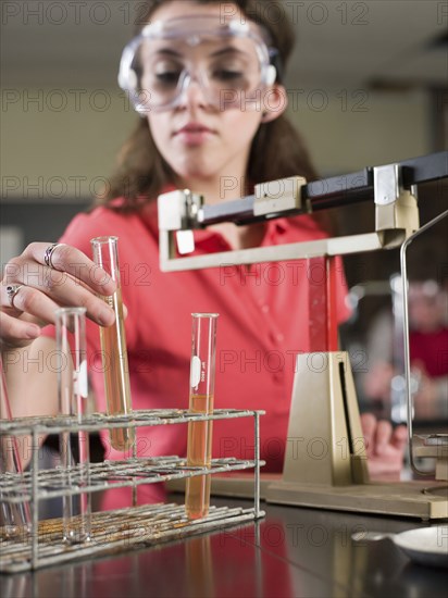 Student examining sample in science lab classroom