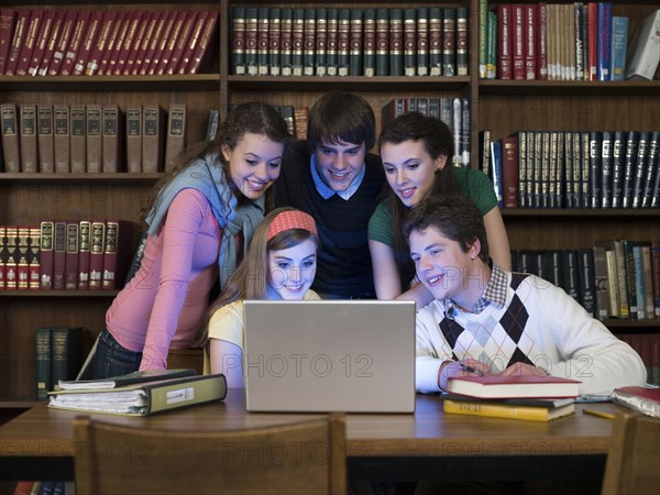 Students using laptop in library