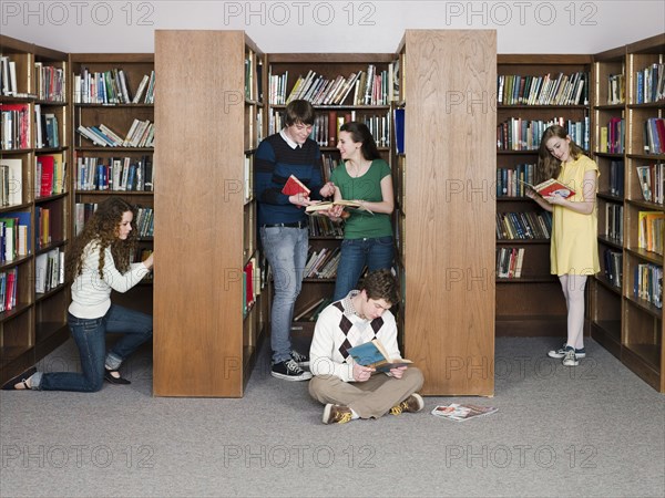 Students reading books in library