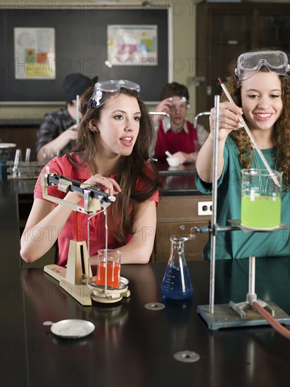 Students performing experiment in science lab classroom