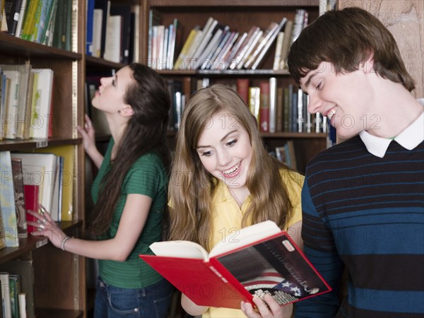 Students reading books in library