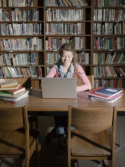 Student using laptop in library