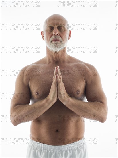 Serene older man meditating