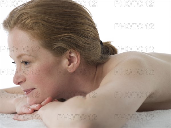 Close up of nude Caucasian woman laying on massage table