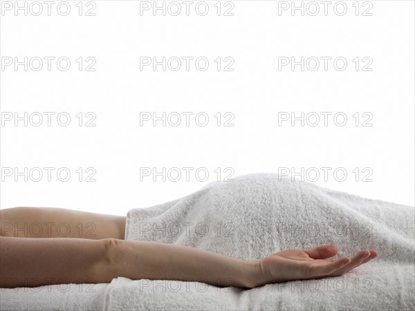 Midsection of woman laying on massage table