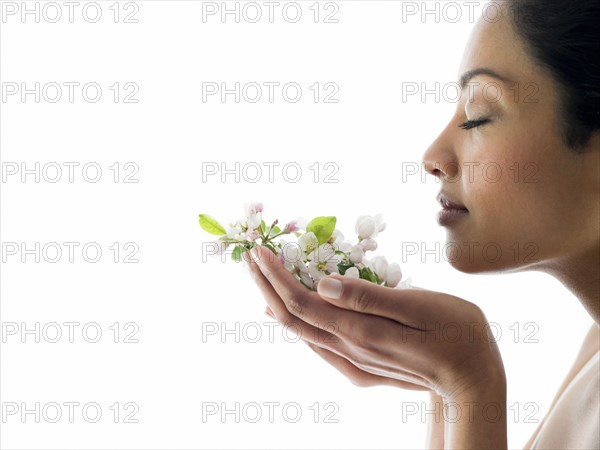 Woman smelling handful of flowers
