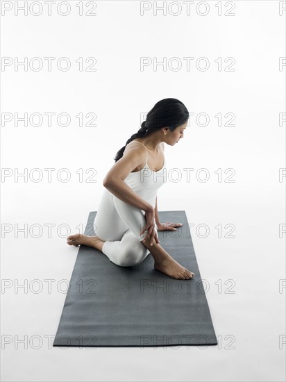 Woman practicing yoga on mat