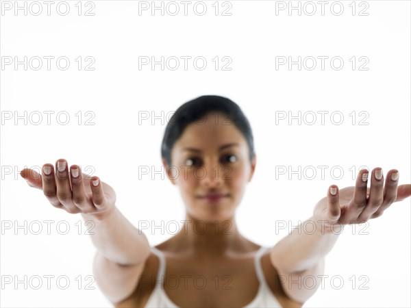 Close up of woman meditating with arms outstretched