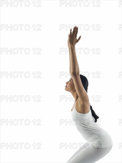 Side view of serene woman practicing yoga