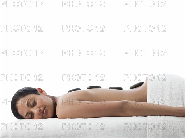 Serene woman having hot stone massage