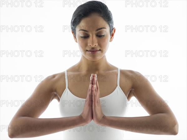 Close up of serene woman meditating