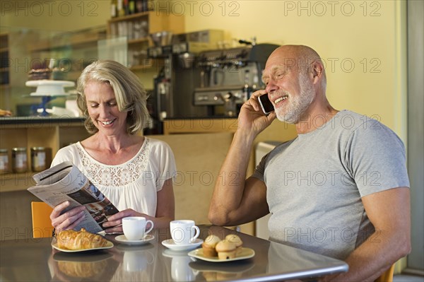 Older couple relaxing in cafe
