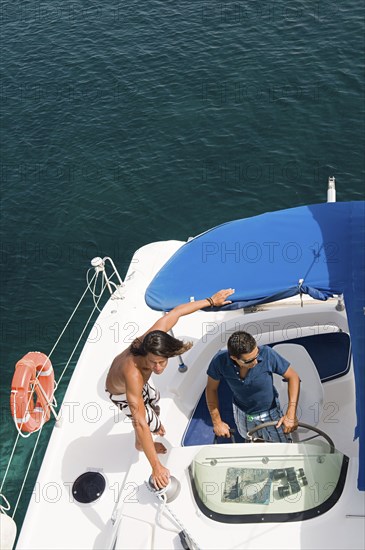 Men driving sailboat on ocean