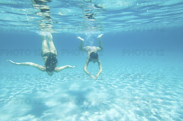 Underwater view of women swimming in ocean