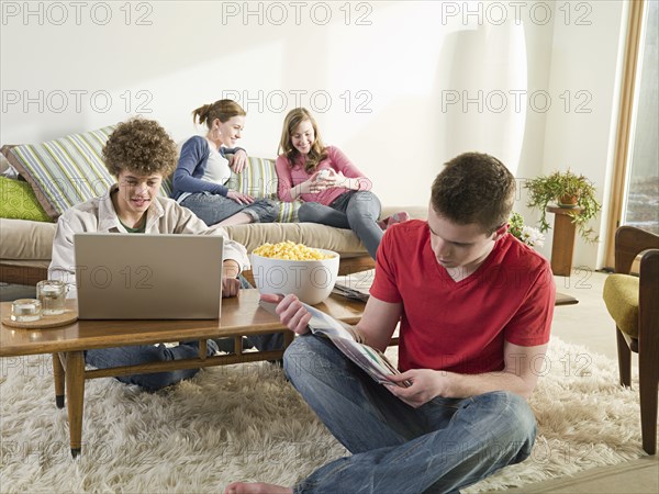 Caucasian friends relaxing in living room