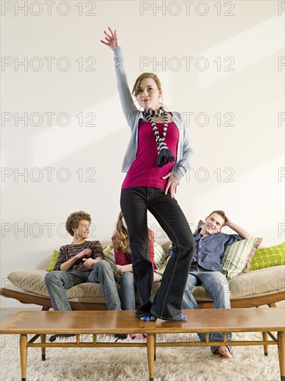 Caucasian woman standing on coffee table