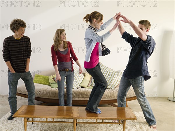 Friends dancing in living room