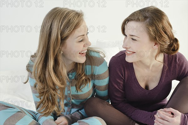 Caucasian women smiling on bed