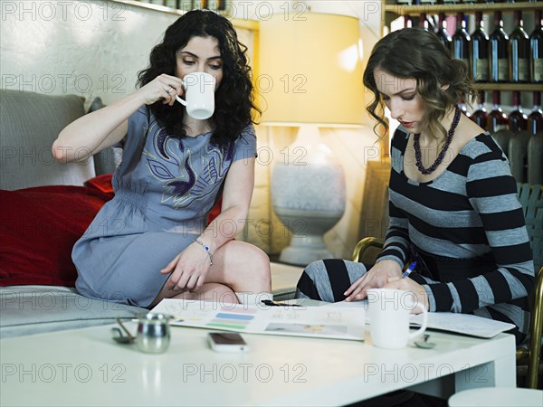 Caucasian business people working in cafe