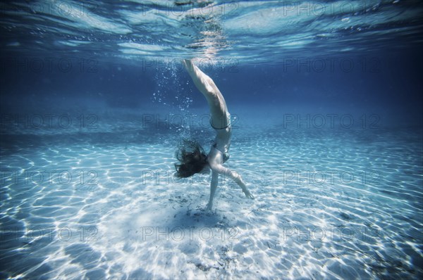 Underwater view of woman swimming in ocean