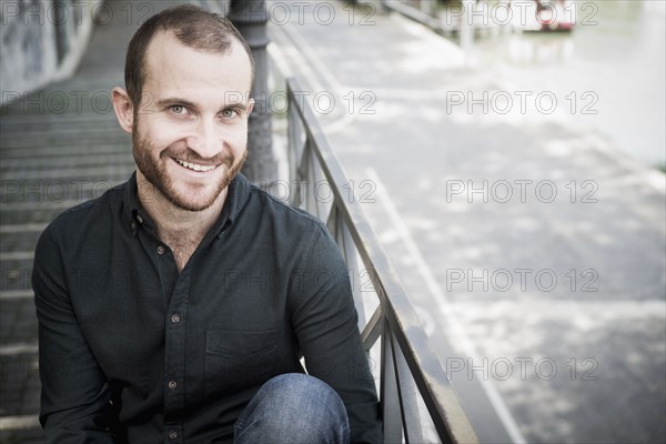 Caucasian man sitting on outdoor staircase