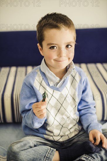 Caucasian boy holding toy soldier