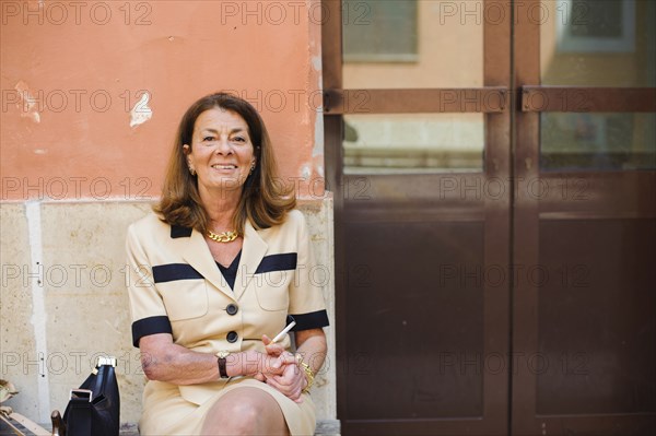 Caucasian woman sitting outdoors