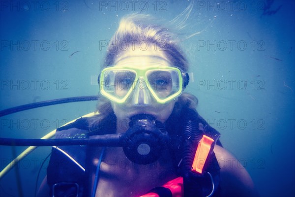 Caucasian diver swimming in ocean