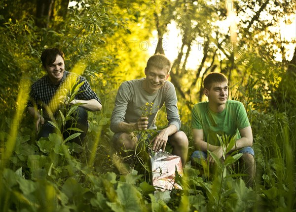 Caucasian men sitting in woods